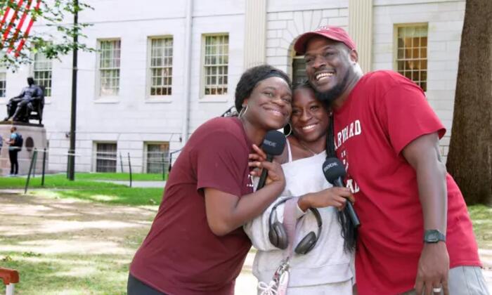A Harvard student and her family on move in day in Harvard Yard. 