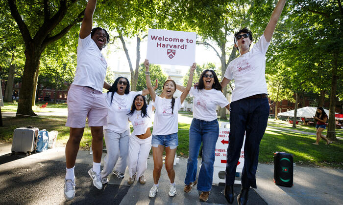 Members of the Crimson Key Society welcome first-year students to Harvard.