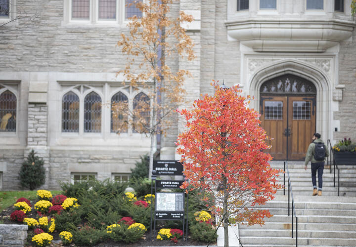 A student walking into Harvard Divinity School’s Schwartz Hall.