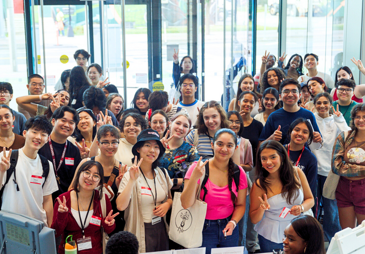 Welcome to Harvard Block Party attendees pose for a group picture.