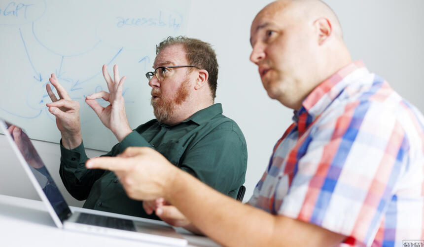 Harvard ASL interpreter Robert G. Lee interpreting during a meeting.