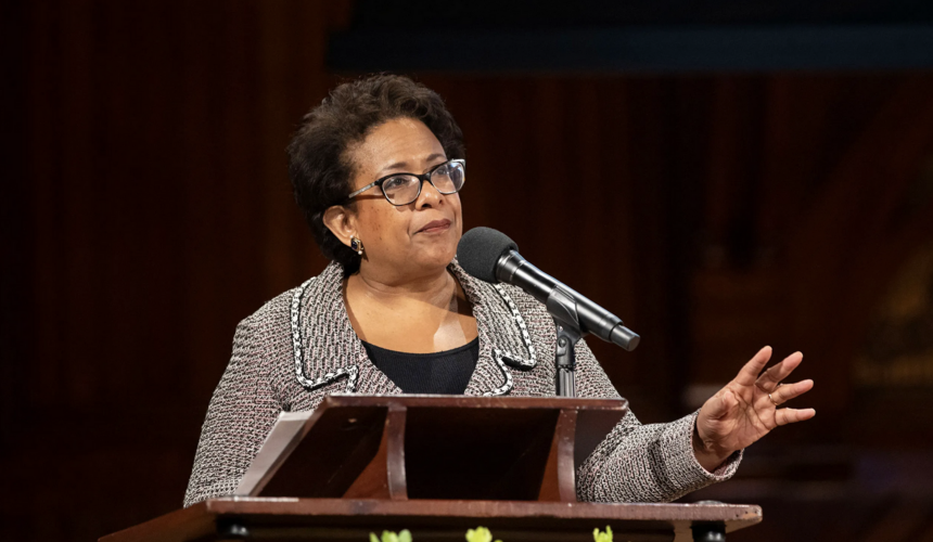 Former Attorney General Loretta Lynch stands at a podium, giving the MLK commemorative lecture.