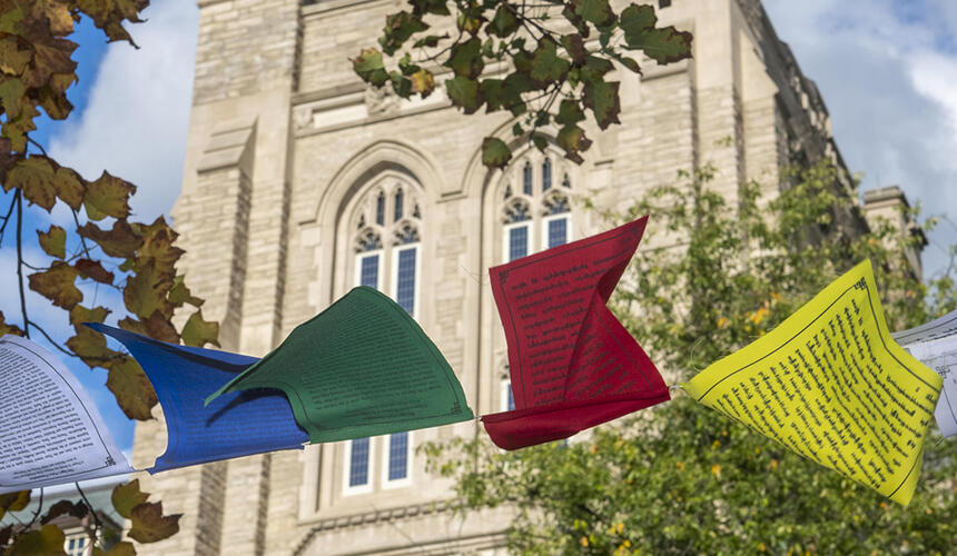 Prayer flags flying in front of a Harvard building. 