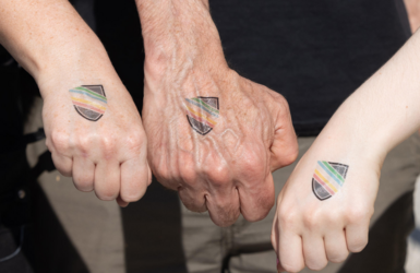 Three hands with Harvard shield stamps on them